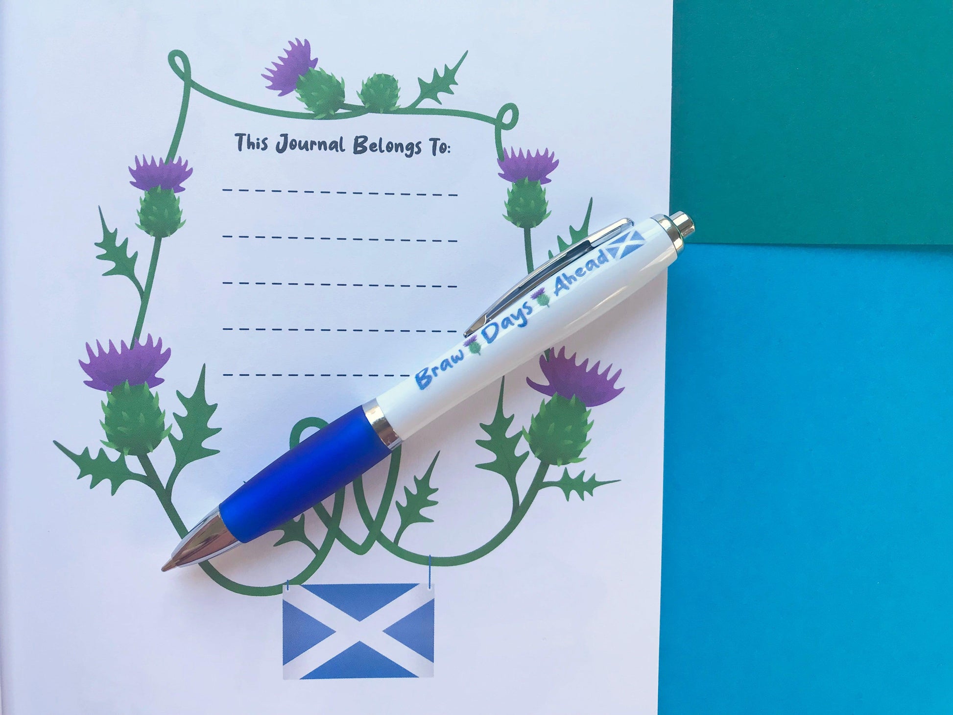 A photo of a journal page with a blue and white pen that says "Braw Days Ahead" on it