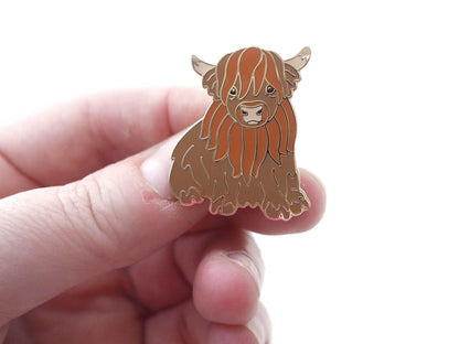Cute Highland Cow Enamel Pin in a Sitting Position