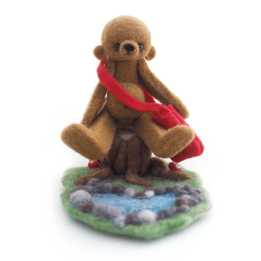 Needle felted Artist Bear with tree stump and pond.